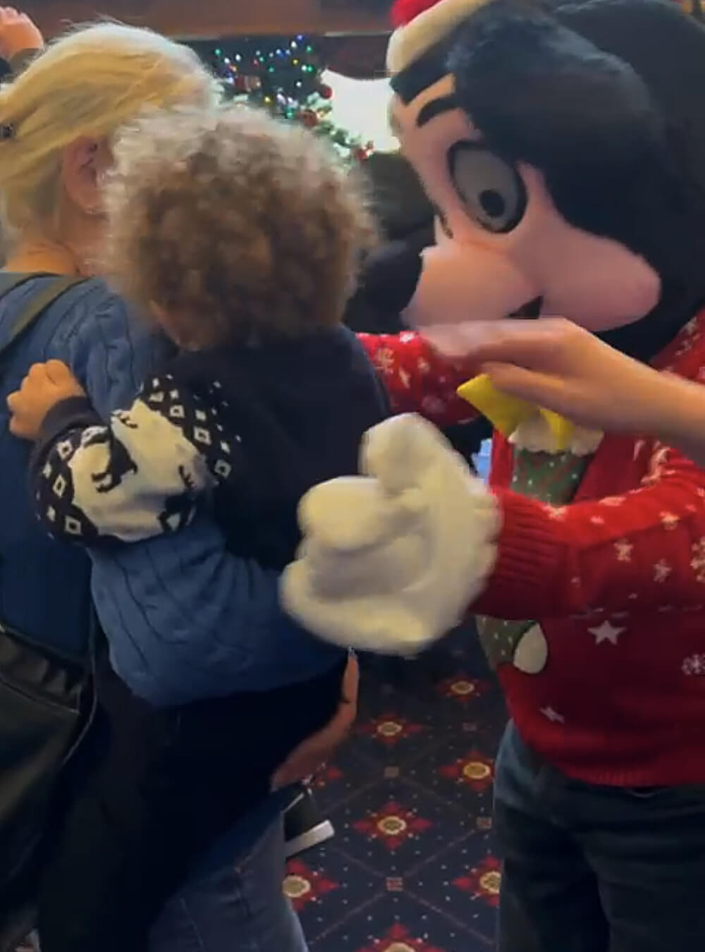 Child being welcomed by Mickey Mouse